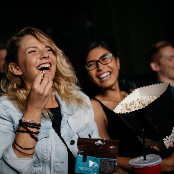 Two Females Enjoying a Film in a Cinema Screening